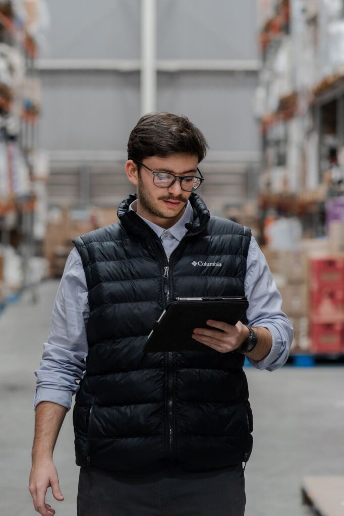 Quality control inspector reviewing warehouse stock on a tablet