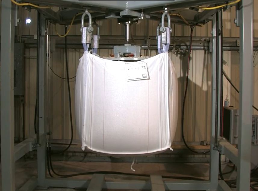 Bulk bag suspended in a top-lift test rig during safety factor certification testing
